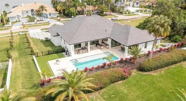 Custom home in Marco Island, a new construction house with a tile roof and a pool
